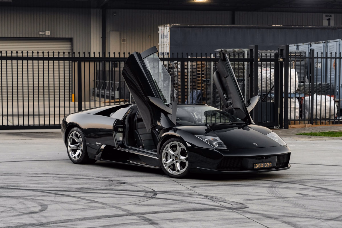 Black 2005 Lamborghini Murcielago Roadster with its scissor doors raised